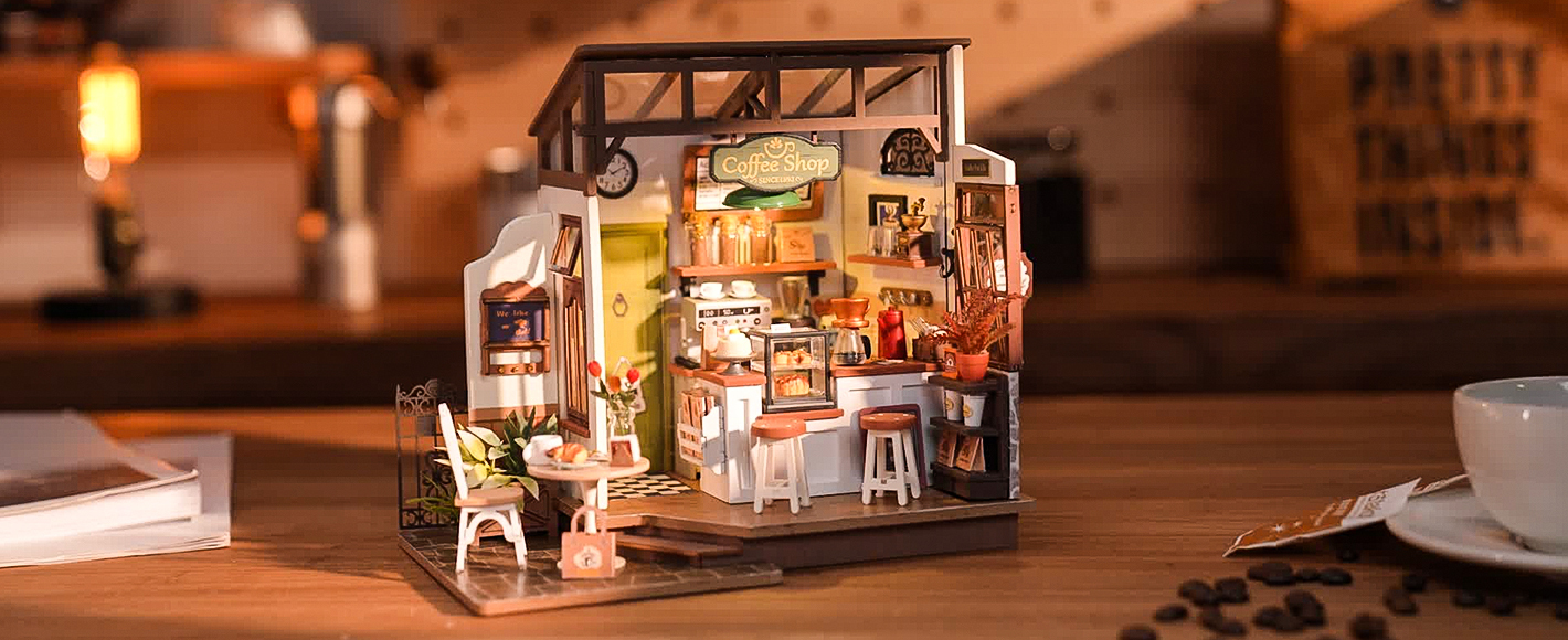 Completed Rolife Coffee Shop miniature house on a warmly lit table