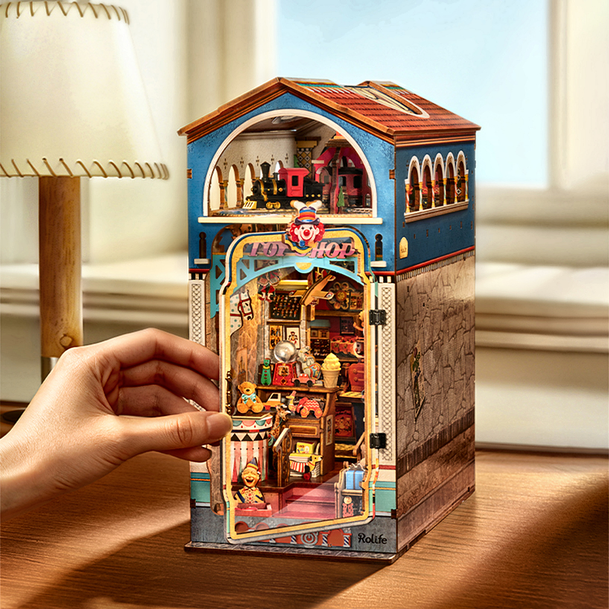 Rolife Treasure Toy Shop DIY Book Nook with opening clear dust cover on desk