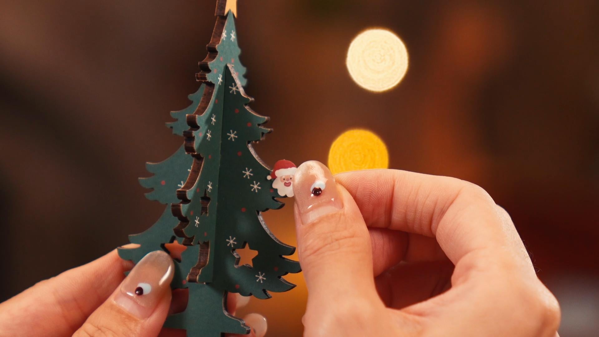 A cute Santa Claus head on the Christmas tree