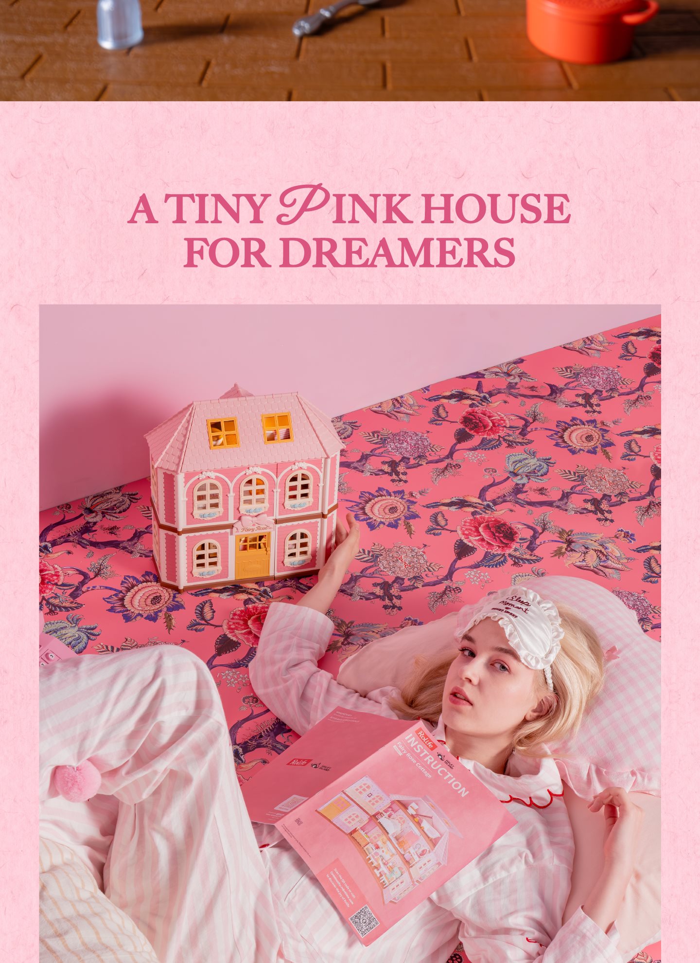 Fairy Rose Cottage pink house scene for dreamers on patterned bed