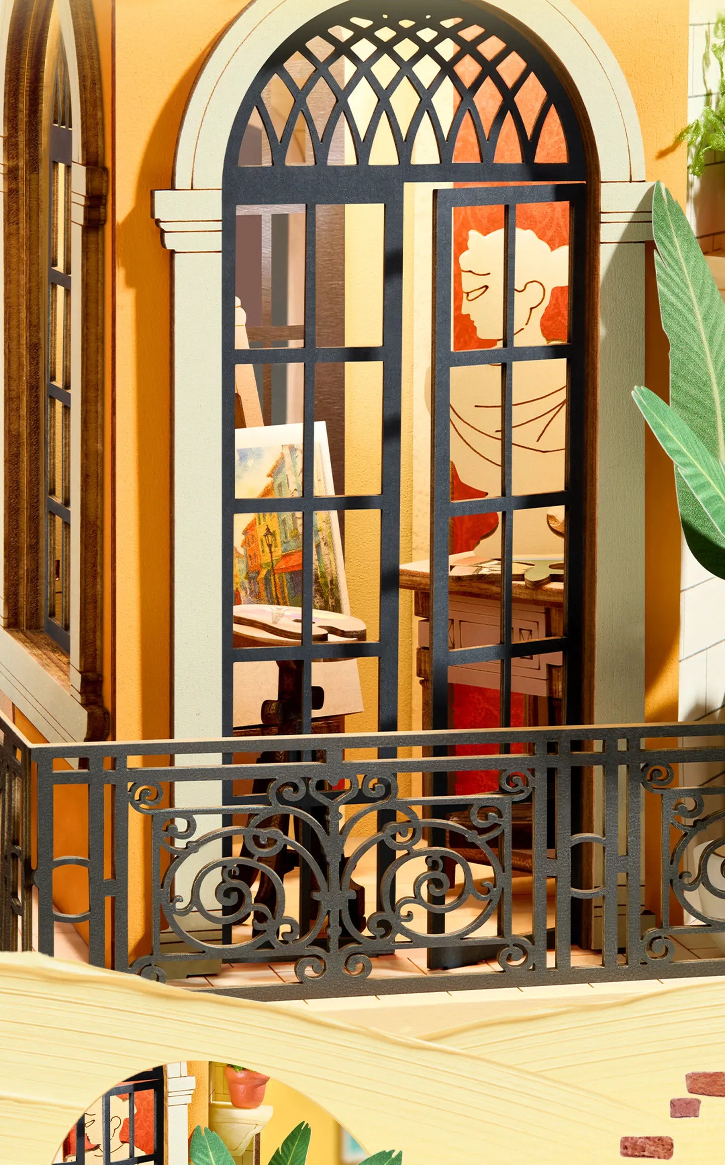 Miniature balcony with ornate black iron railing and arched black-framed doors, revealing an artist's easel, canvas, and palette inside.