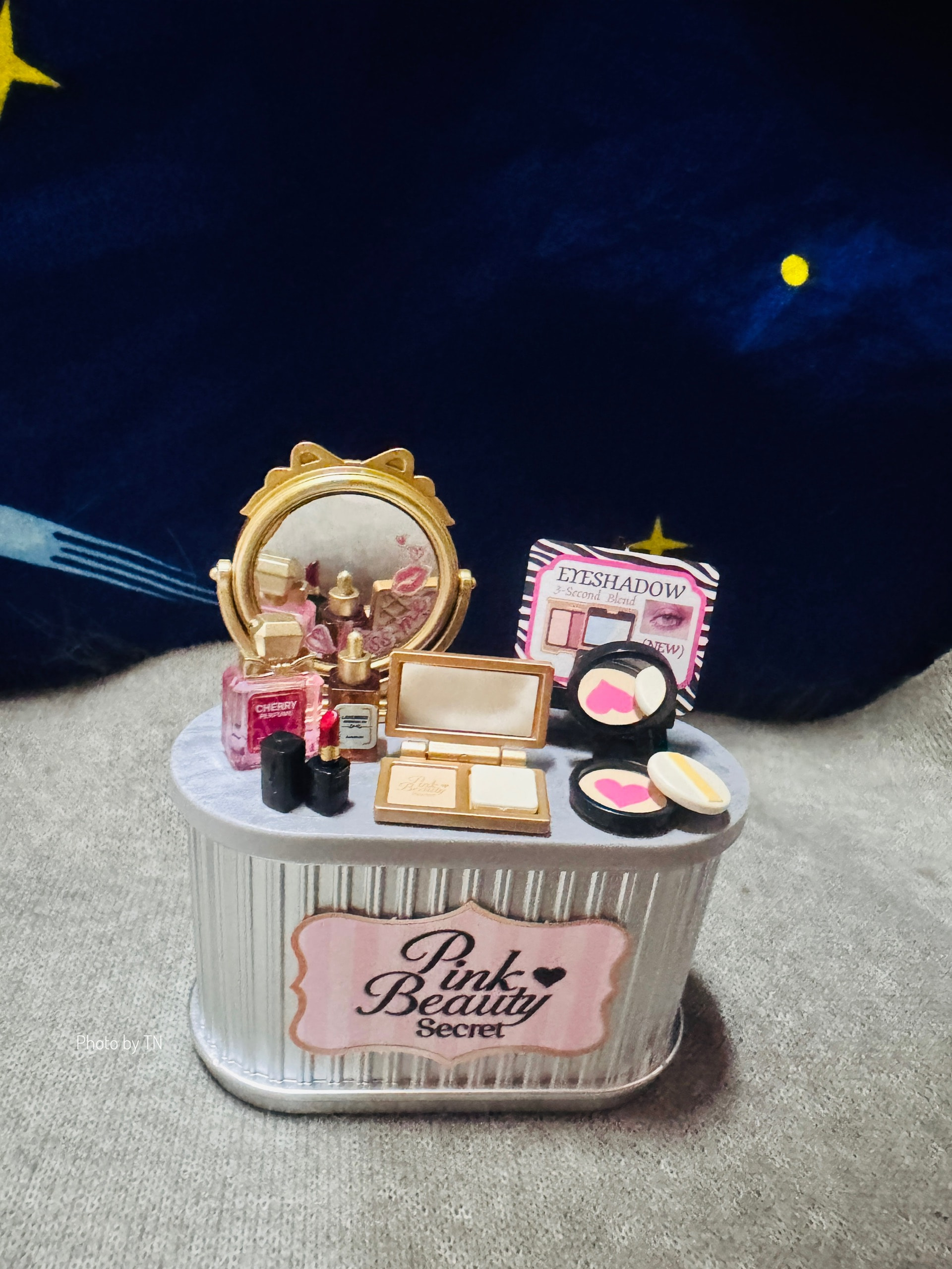 Pink Beauty Secret counter filled with miniature cosmetics, photographed by ThaoNguyen