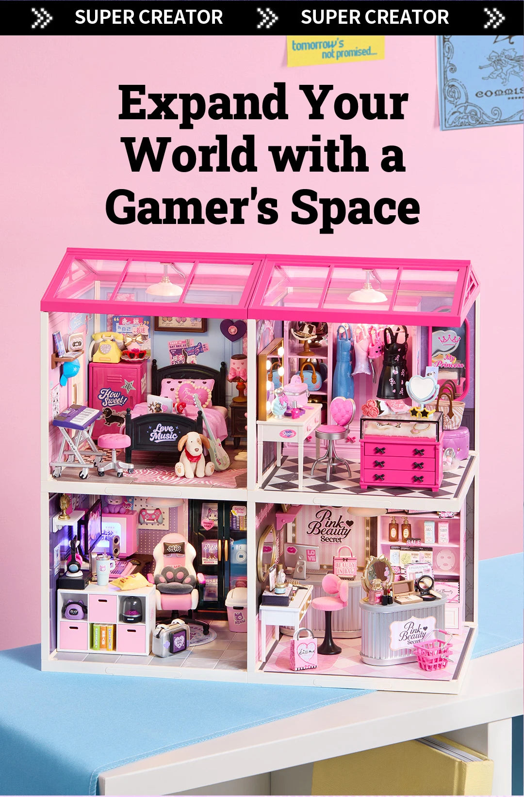 Four-room miniature dollhouse with pink glass roofs, showing a bedroom, dressing area, gaming room and pink beauty shop, displayed on a pale blue surface against a pink background.