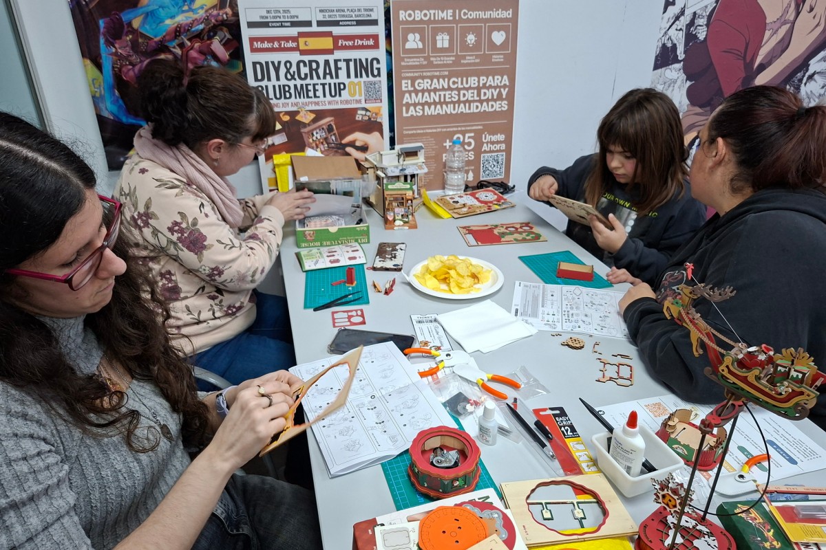 DIY enthusiasts concentrating on building Robotime miniature kits at the Barcelona meetup in Spain.
