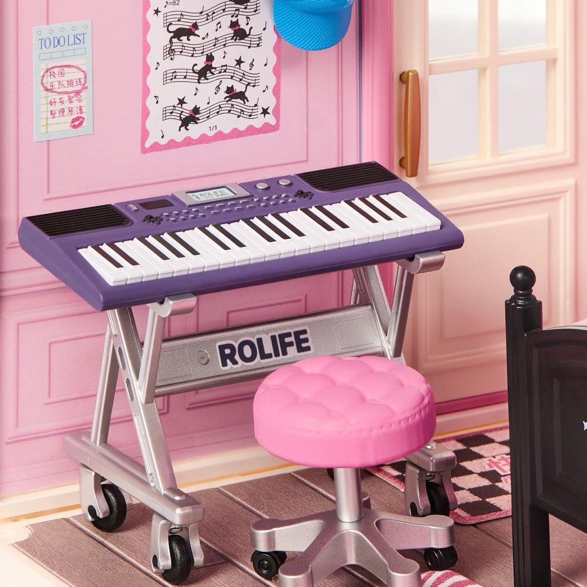 Bedroom Pop miniature keyboard and pink swivel stool beside the music-themed wall