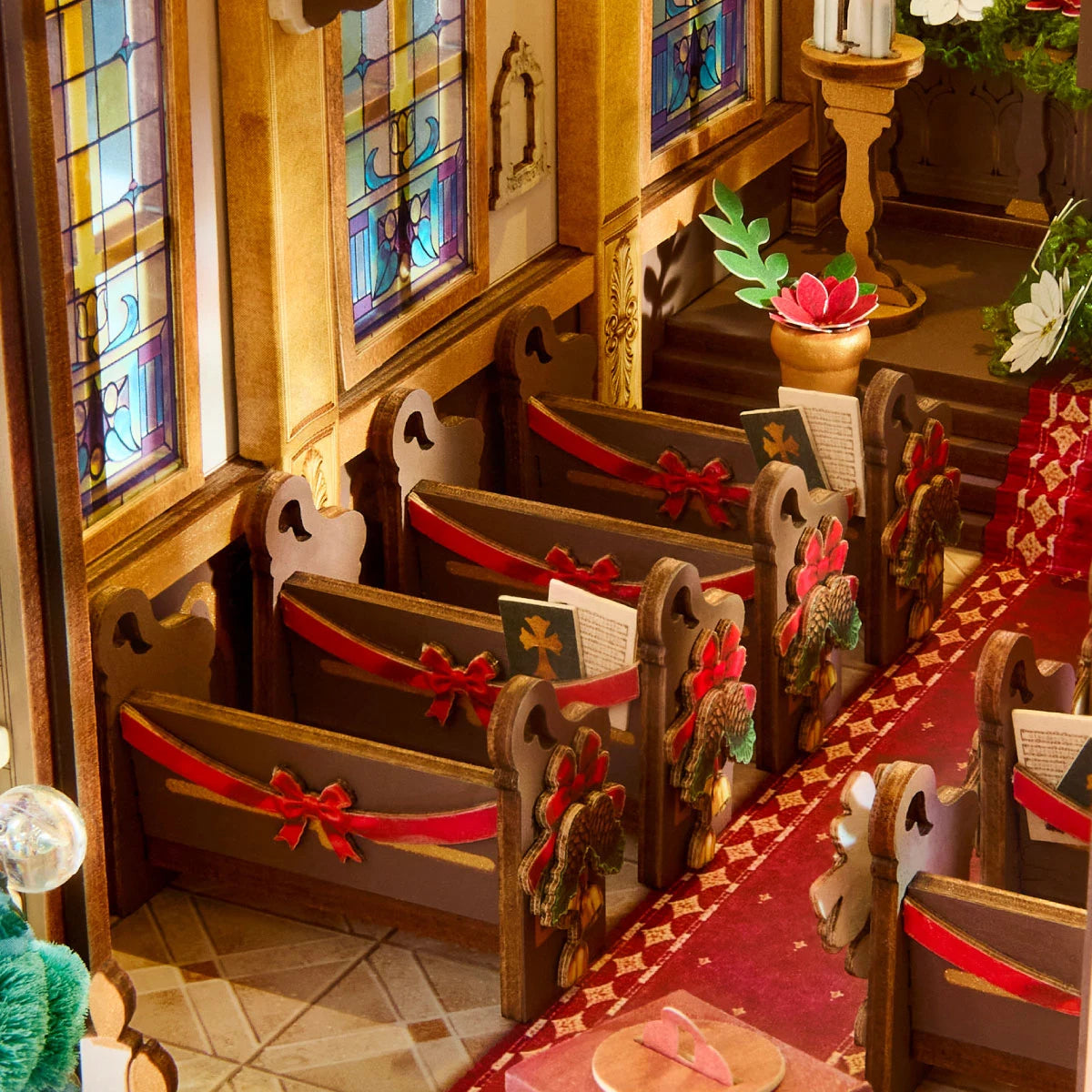 Miniature cathedral pews, hymn books, stained-glass windows, and red carpet inside Caroling Cathedral