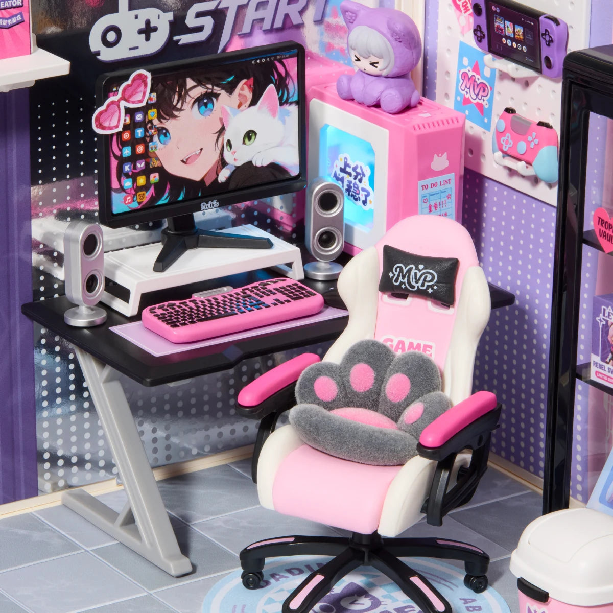 Gamer Queen desk close-up with a pink keyboard, miniature monitor, and cat-paw gaming chair
