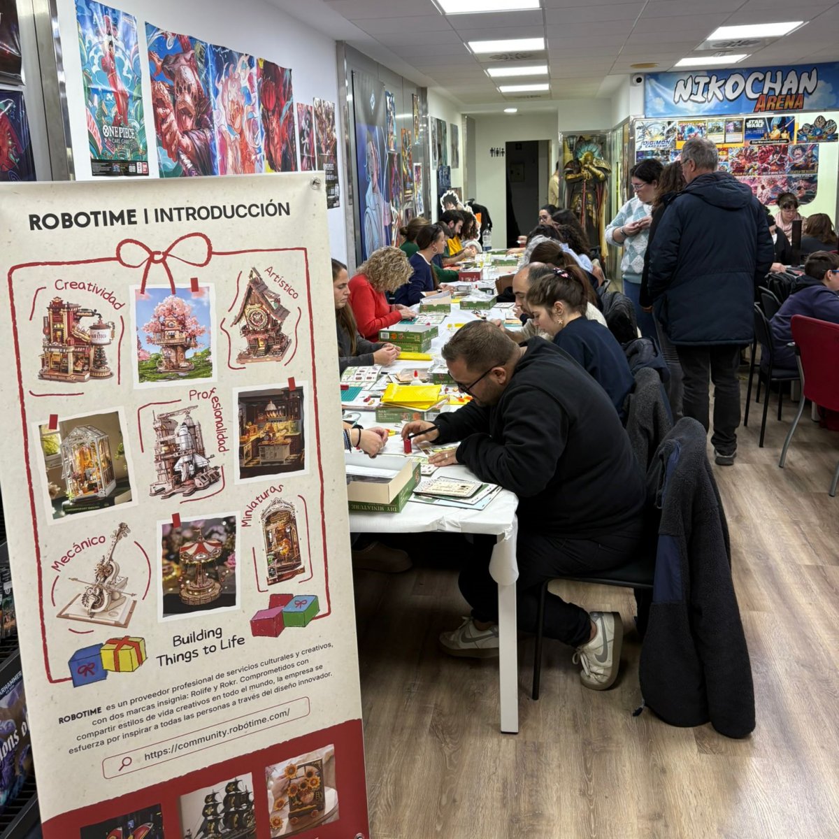 Close-up of participants assembling Robotime Christmas-themed DIY kits at the Spain meetup in Barcelona.