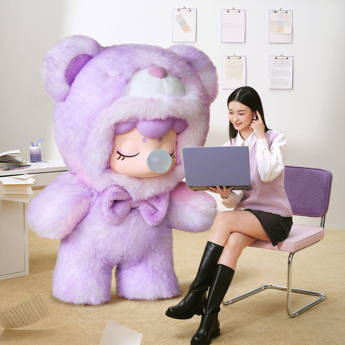 Purple Flying Inspiration Nanci Bear plush pendant attached to a bag
