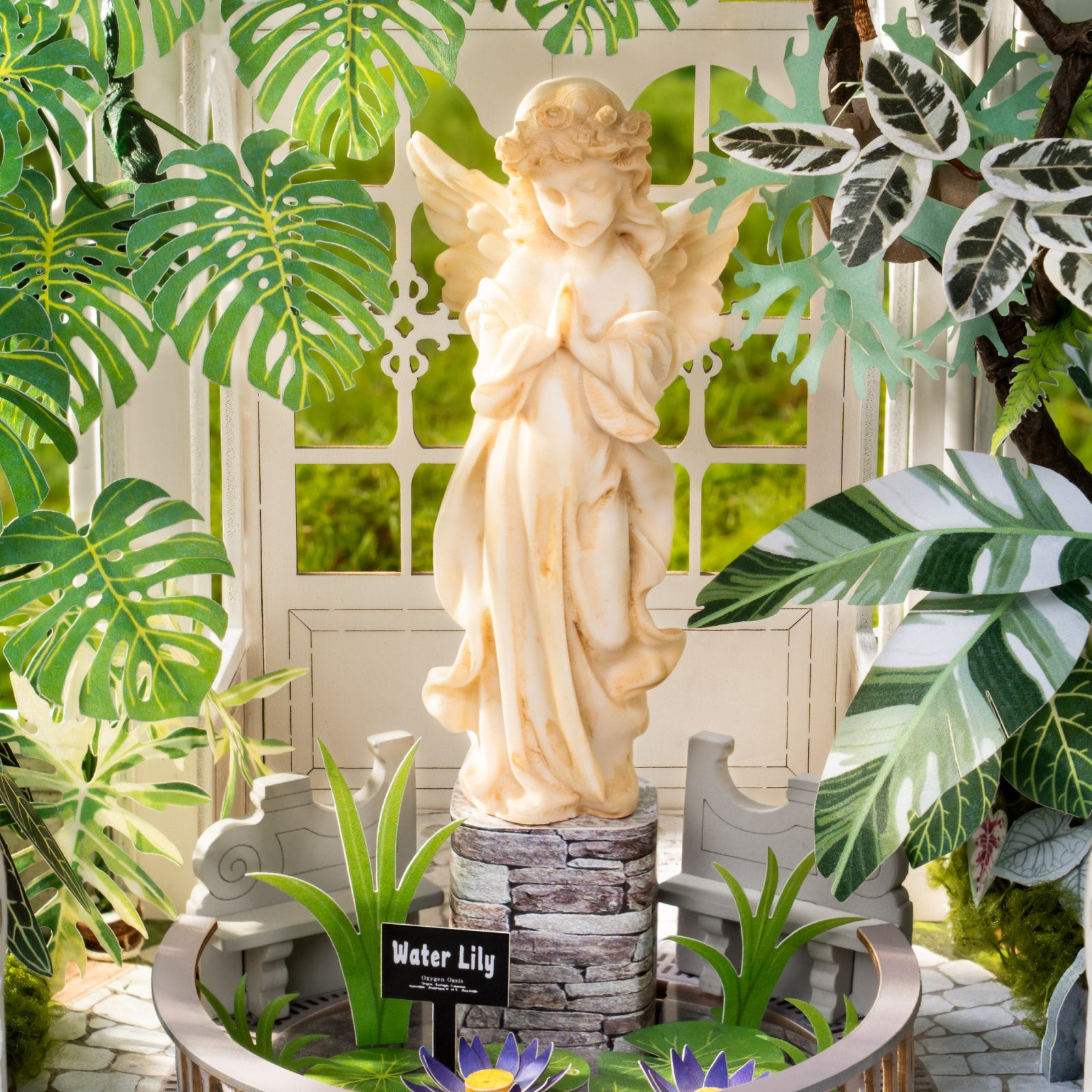 Oxygen Oasis interior with an angel statue, water lilies, and tropical plants