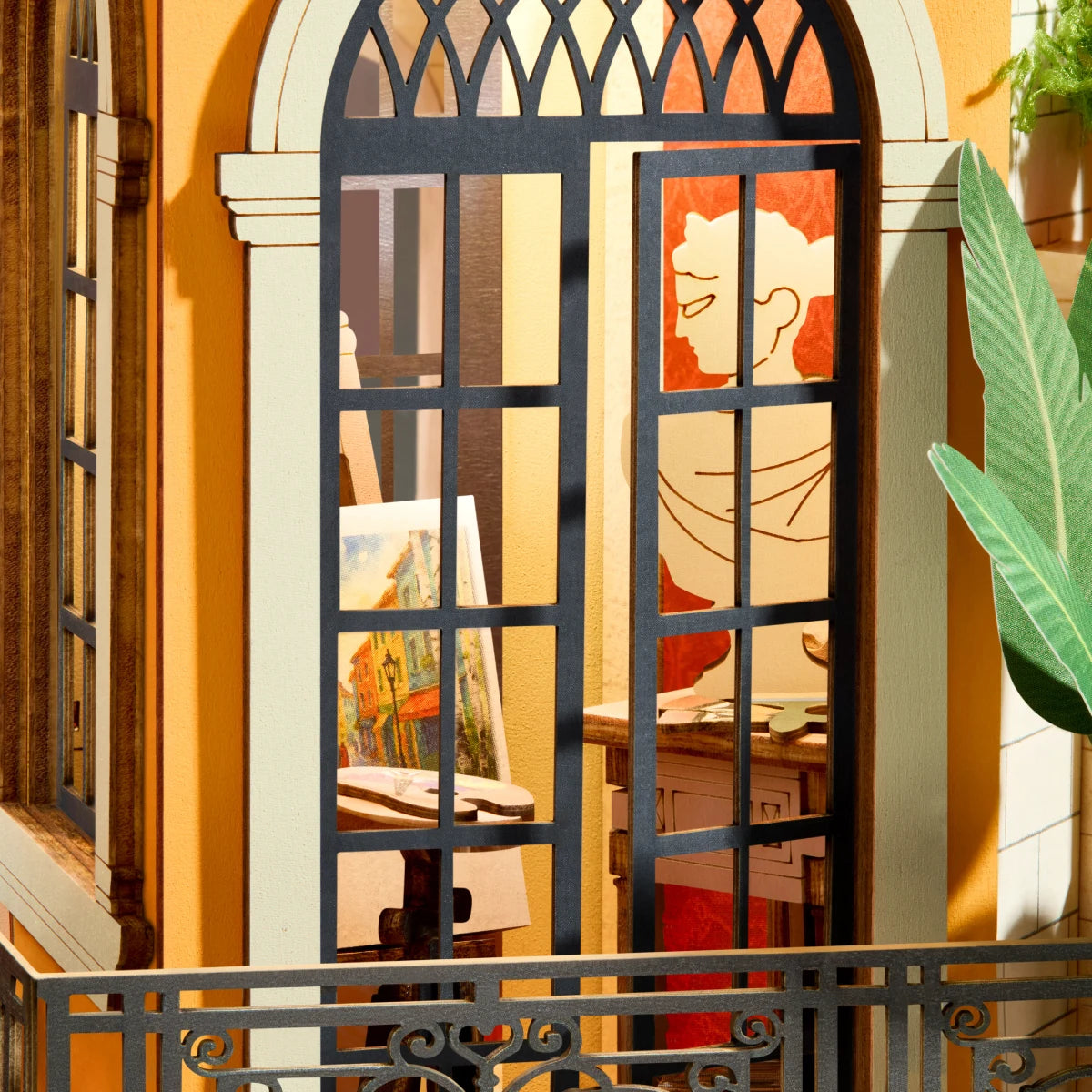 Romantic Art Lane gallery studio seen through an arched window with easel, artwork, and greenery