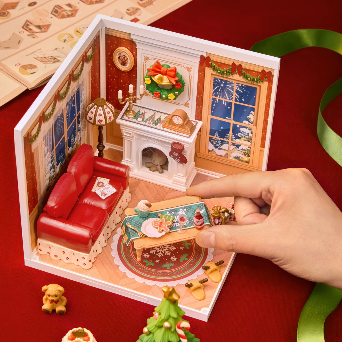 A hand placing a miniature bottle inside Twinkling Christmas Eve DWZ03 during assembly