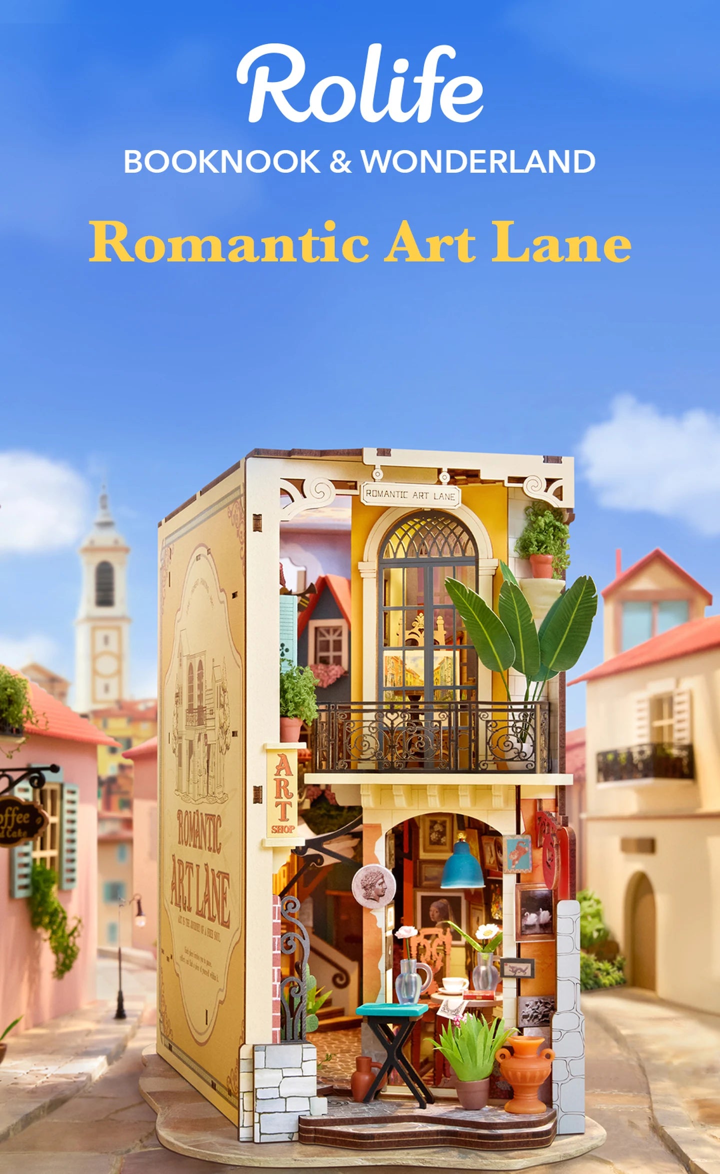 Rolife miniature two-storey art shop diorama with arched window, balcony, plants and caf&eacute; display, set against a blurred pastel street scene.