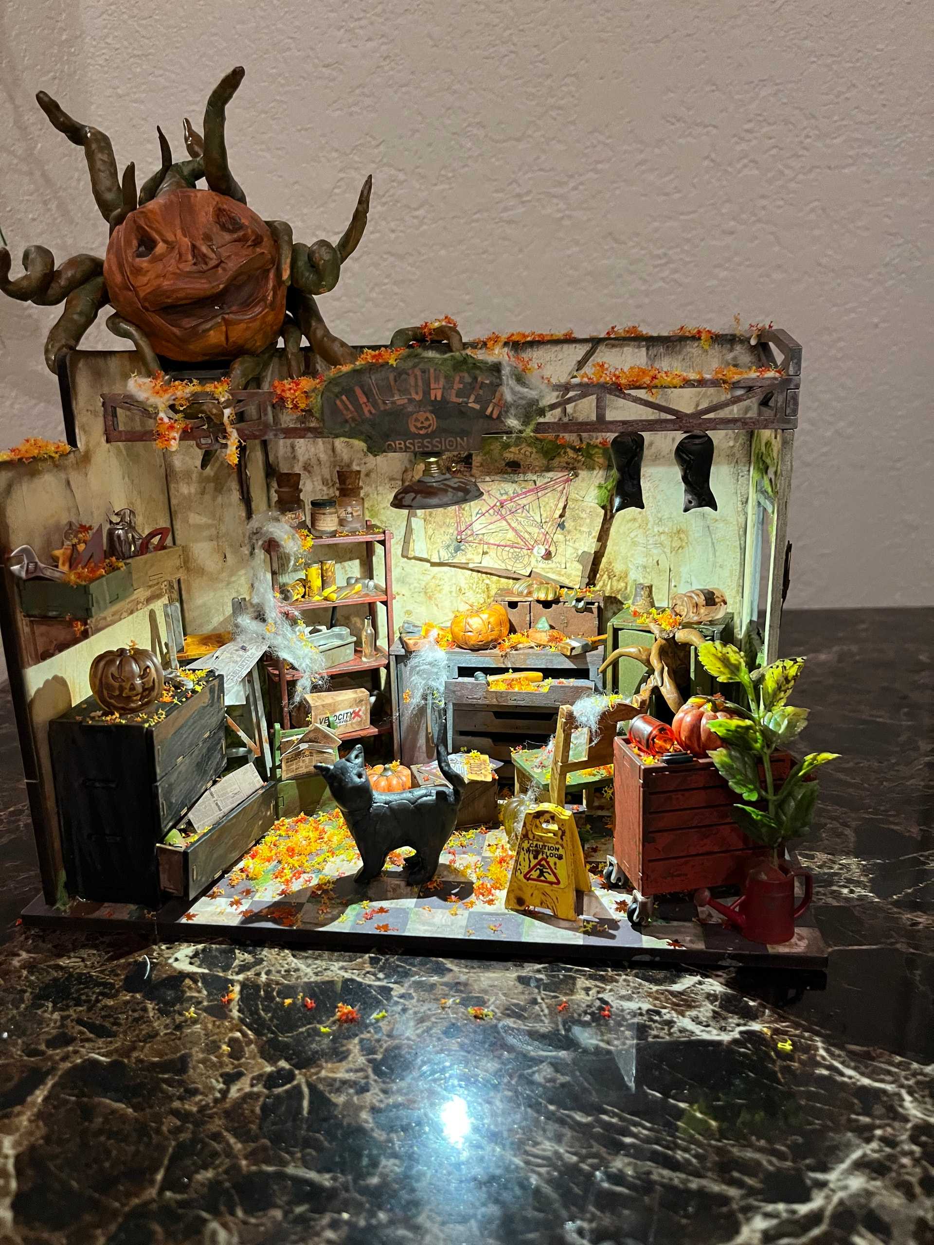 Rukya_Alkaabi's completed Garage Workshop DG165 Halloween makeover with a pumpkin creature above the room