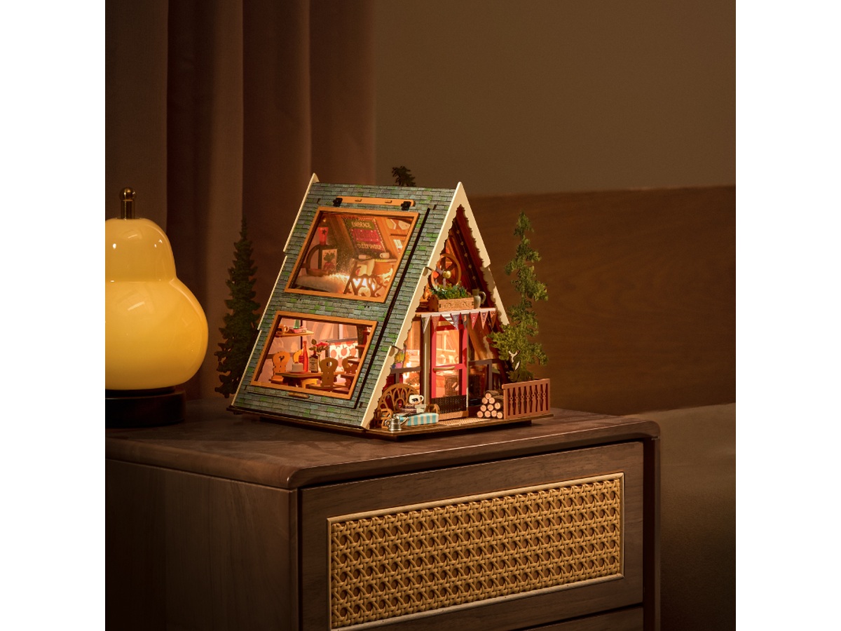 Illuminated Rolife A-Frame Cabin DG181 displayed on a wooden cabinet