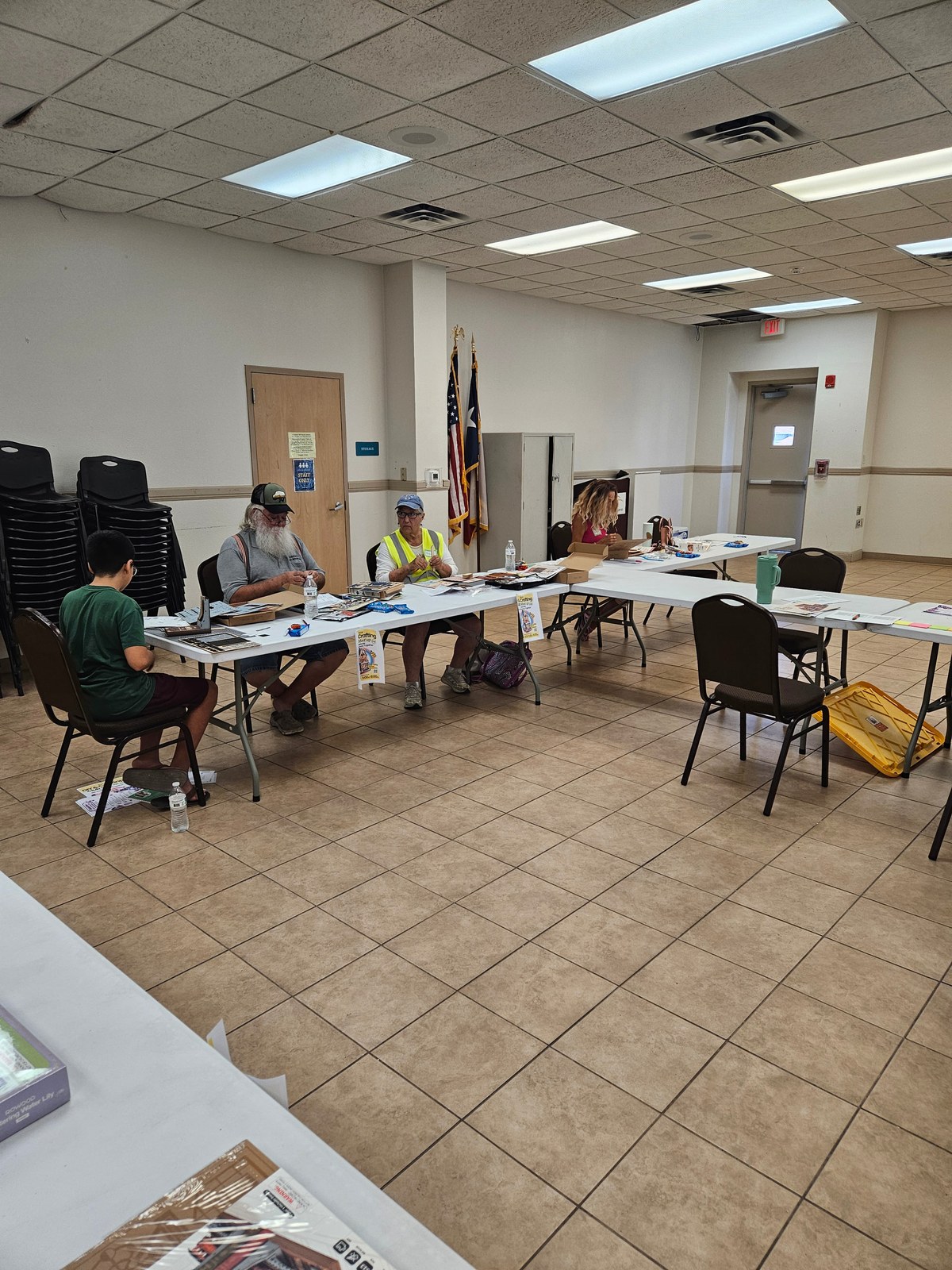 Adults and children building DIY projects at tables in Copperas Cove
