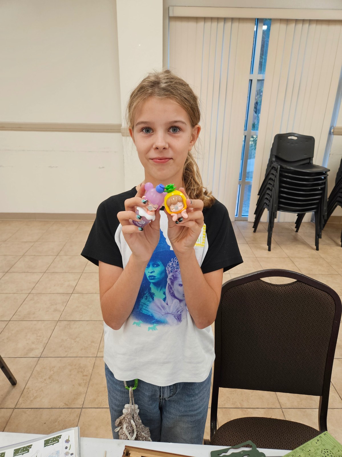 A participant holding two Nanci collectibles at the Copperas Cove meetup