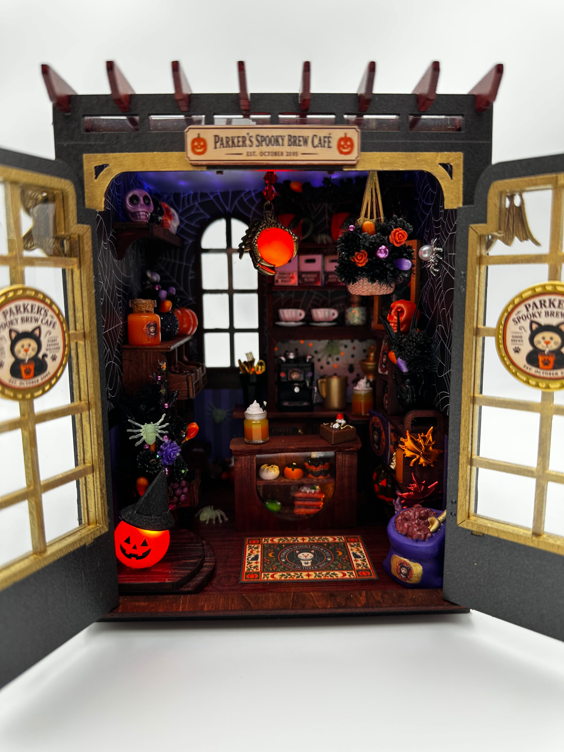 NoodleSalad's Secret Bloomy Nook Halloween cafe with doors open, spiderweb walls, and custom orange lighting