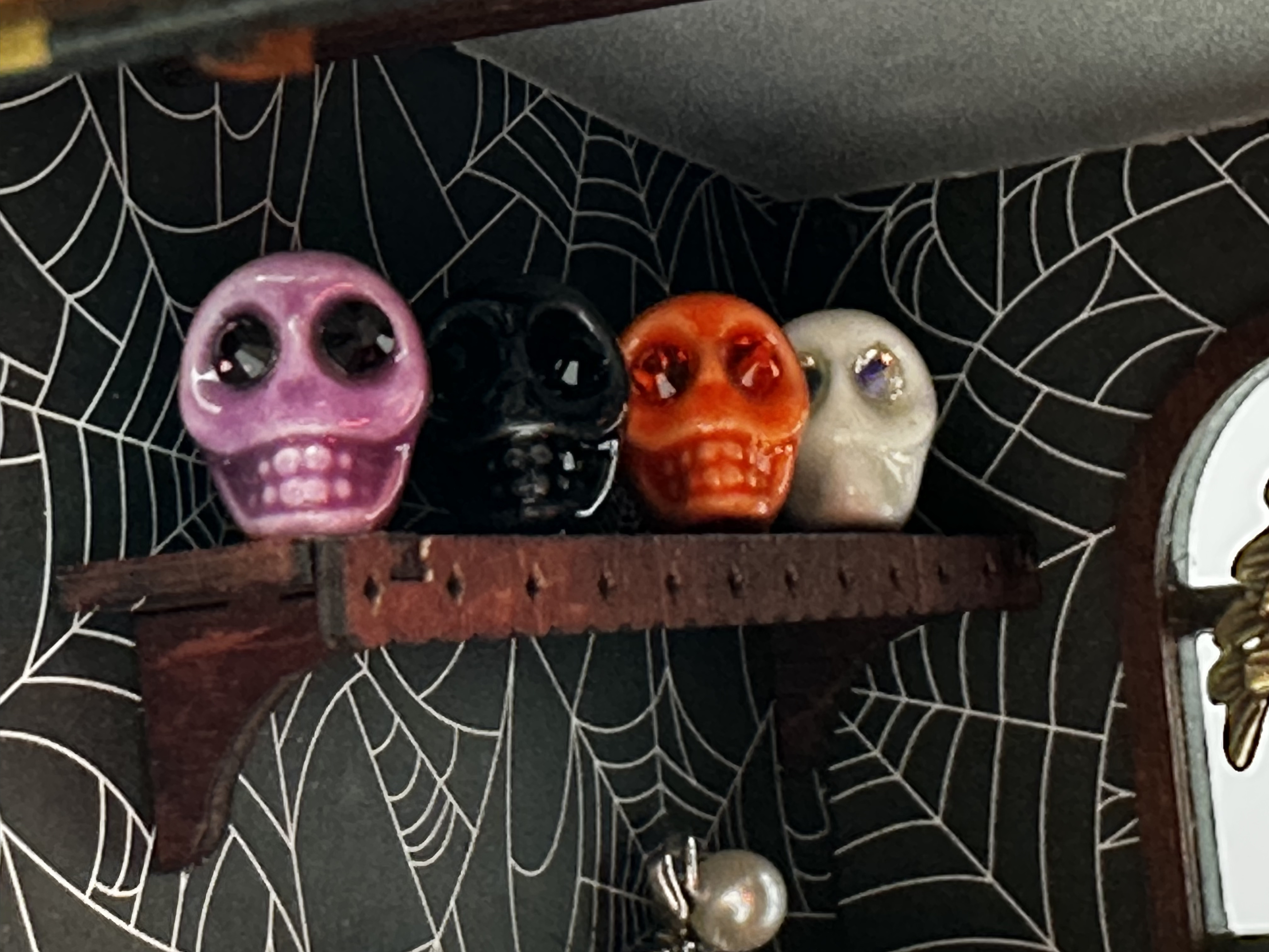 Custom skull decorations against spiderweb scrapbook-paper walls in NoodleSalad's Halloween cafe