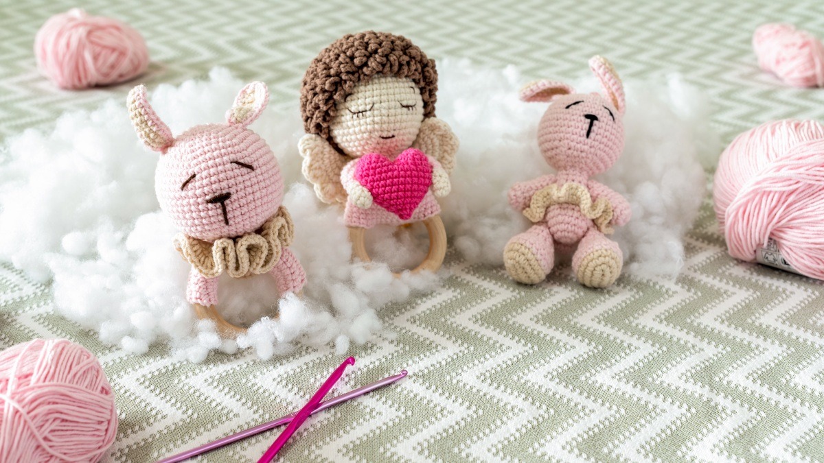 Handmade crochet figures and yarn arranged for a cozy at-home crochet hobby
