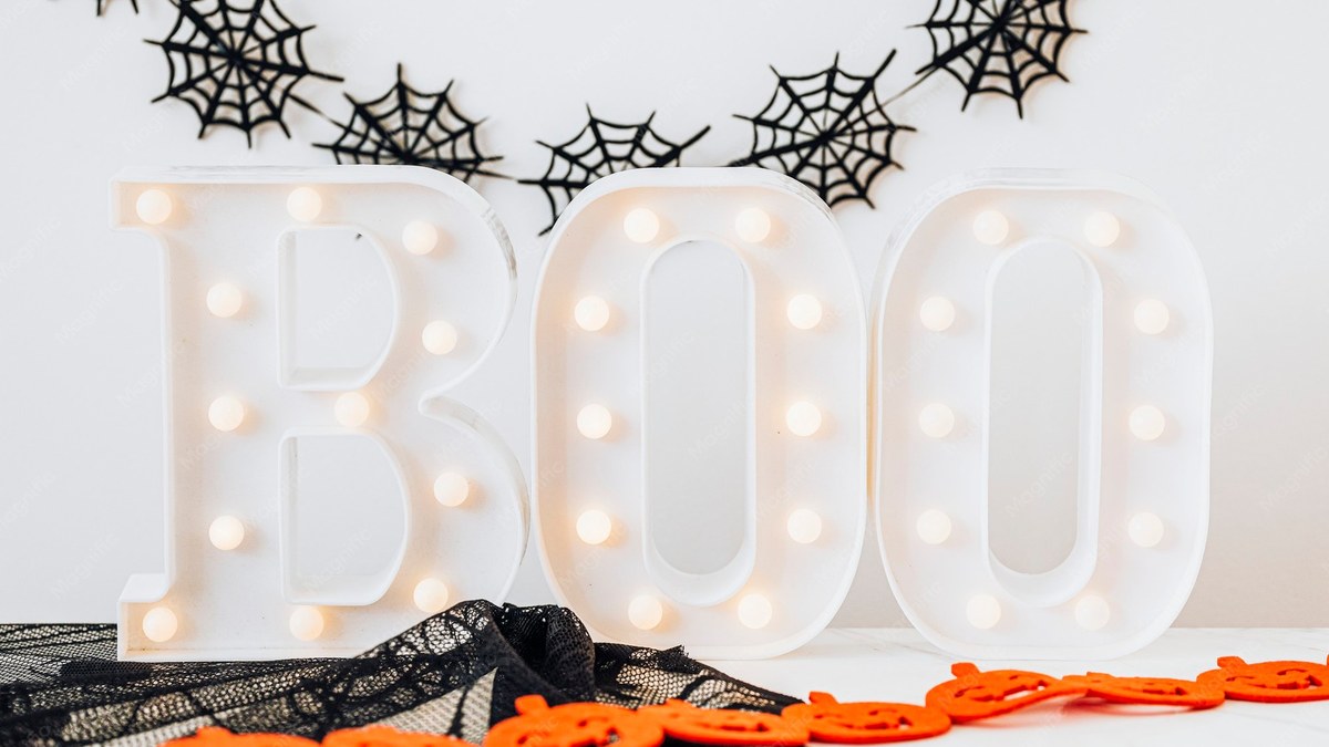 Lighted boo sign on a table with Halloween decoration