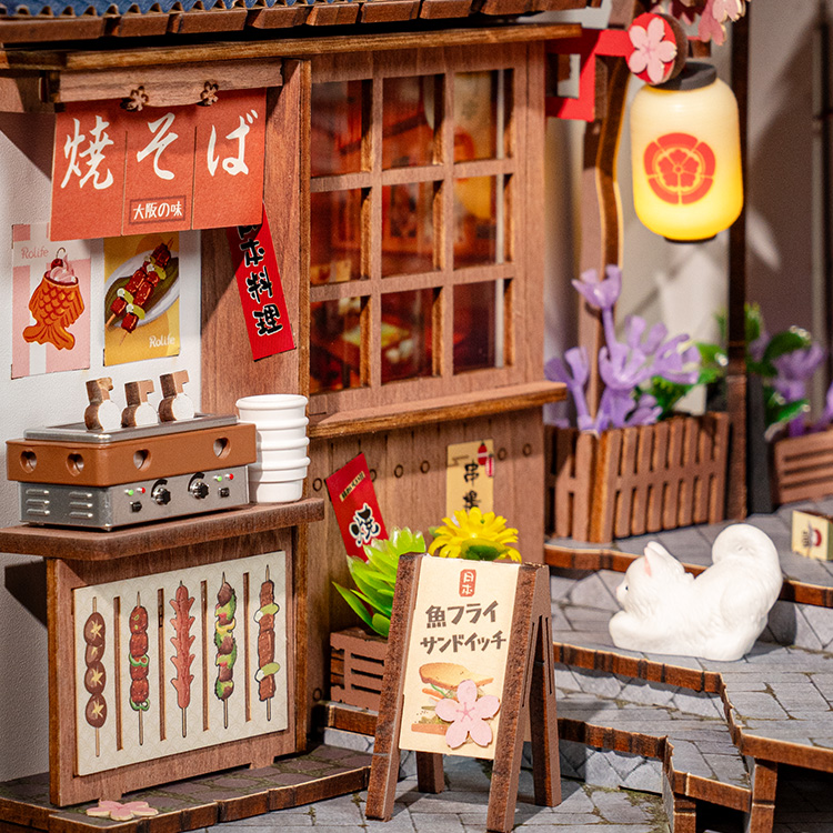Miniature Japanese alley storefront with lantern and street food
