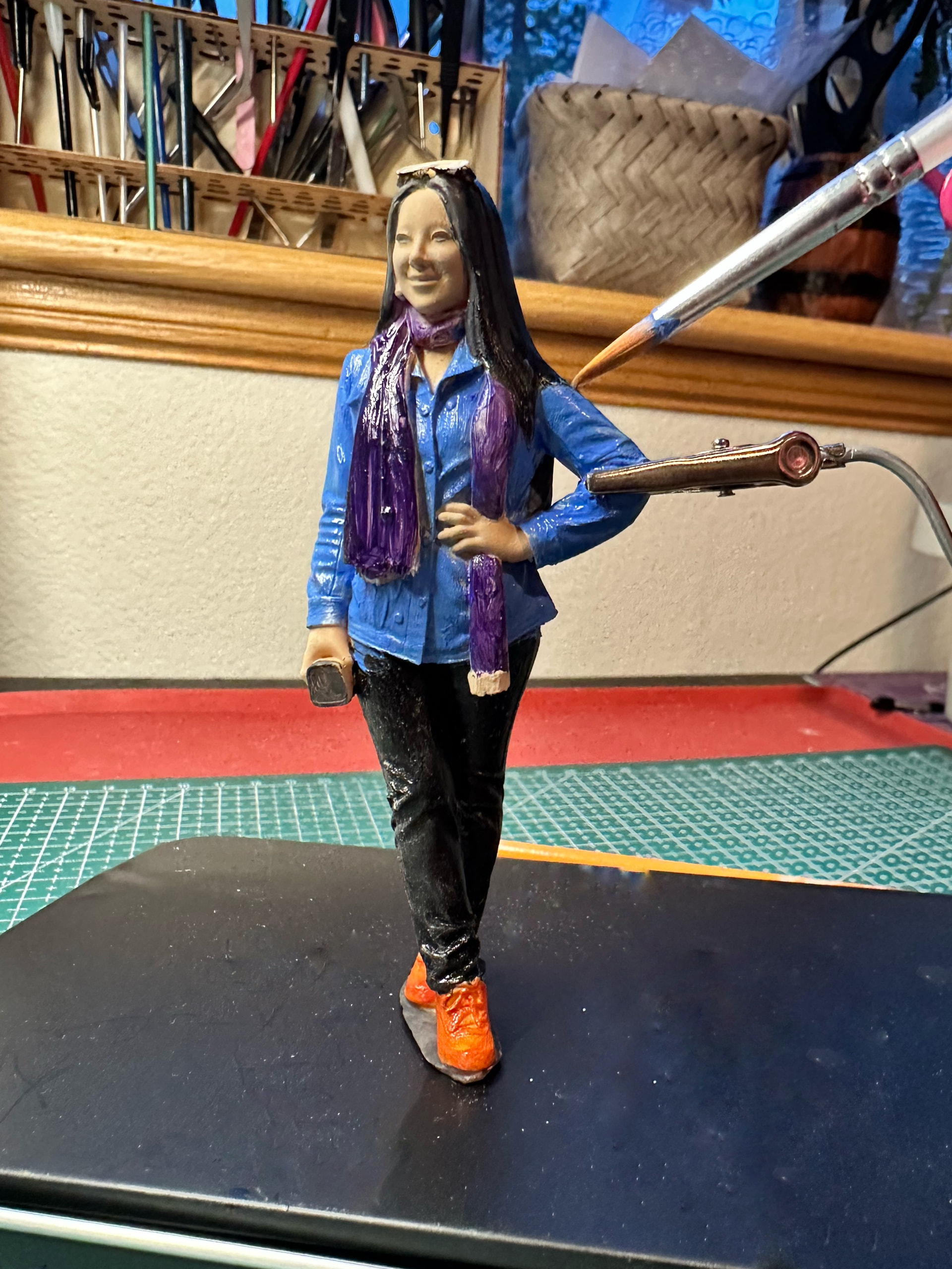 Rolife Community creator painting a 3D-printed miniature self-portrait by hand