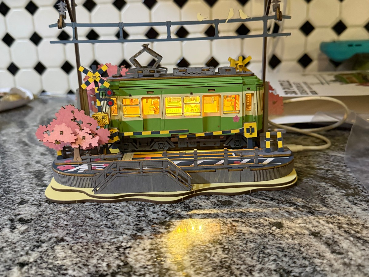 A completed Sakura Journey wooden model glowing at home after the meetup