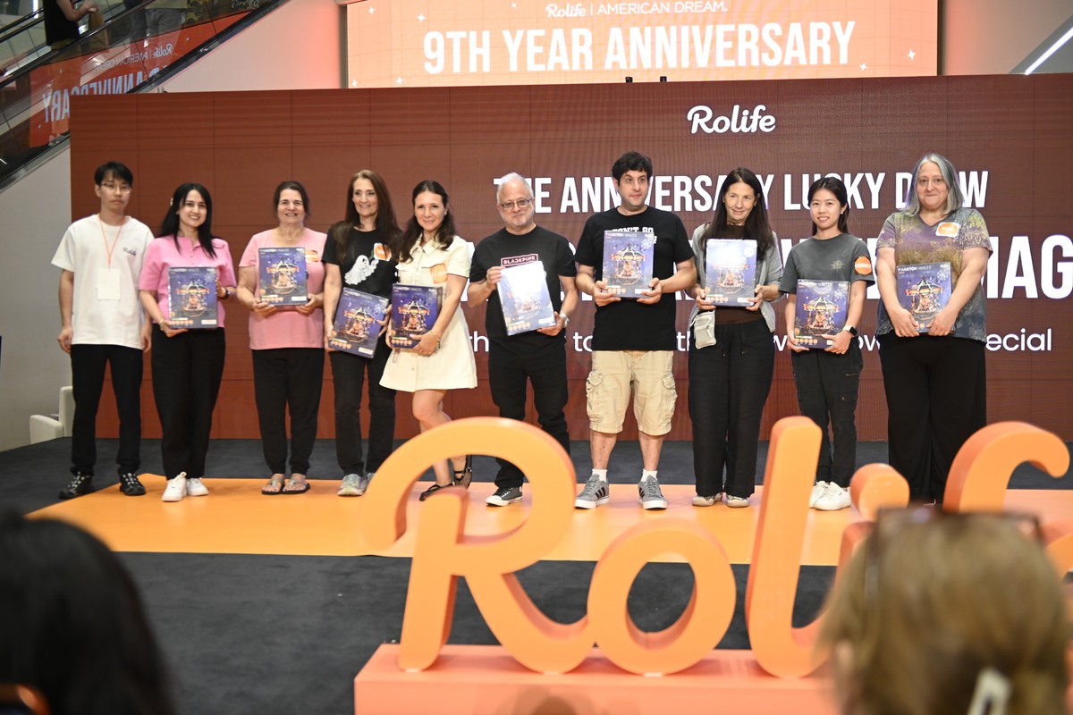 Nine Rolife anniversary raffle winners holding their prizes