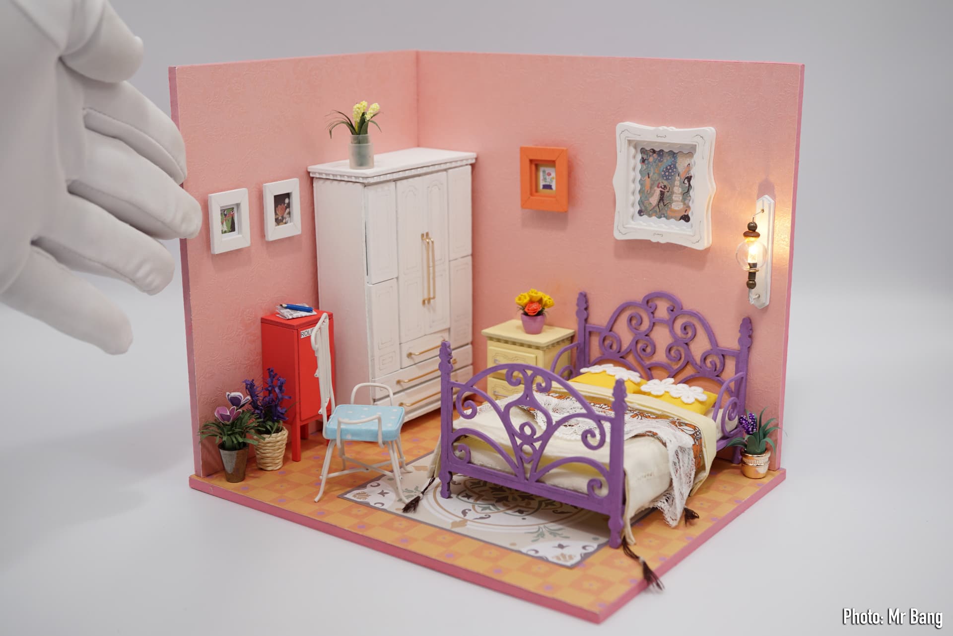 Rolife Community bedroom customization with a pink room, purple bed, wardrobe, plants, and wall light