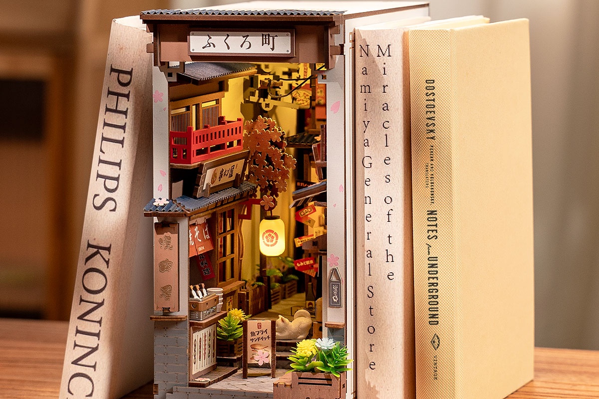 Rolife Sakura Wine Alley TGB11 glowing between books as a Japanese-inspired book nook