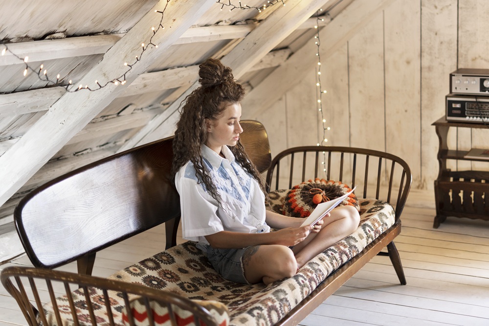 A woman quietly reading a book in a chair