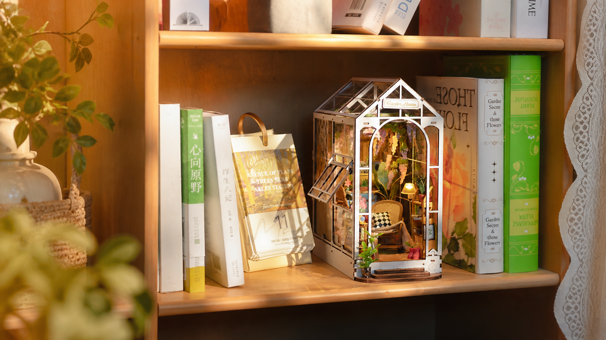 Holiday Garden House TGB06 styled between books on a secret garden bookshelf