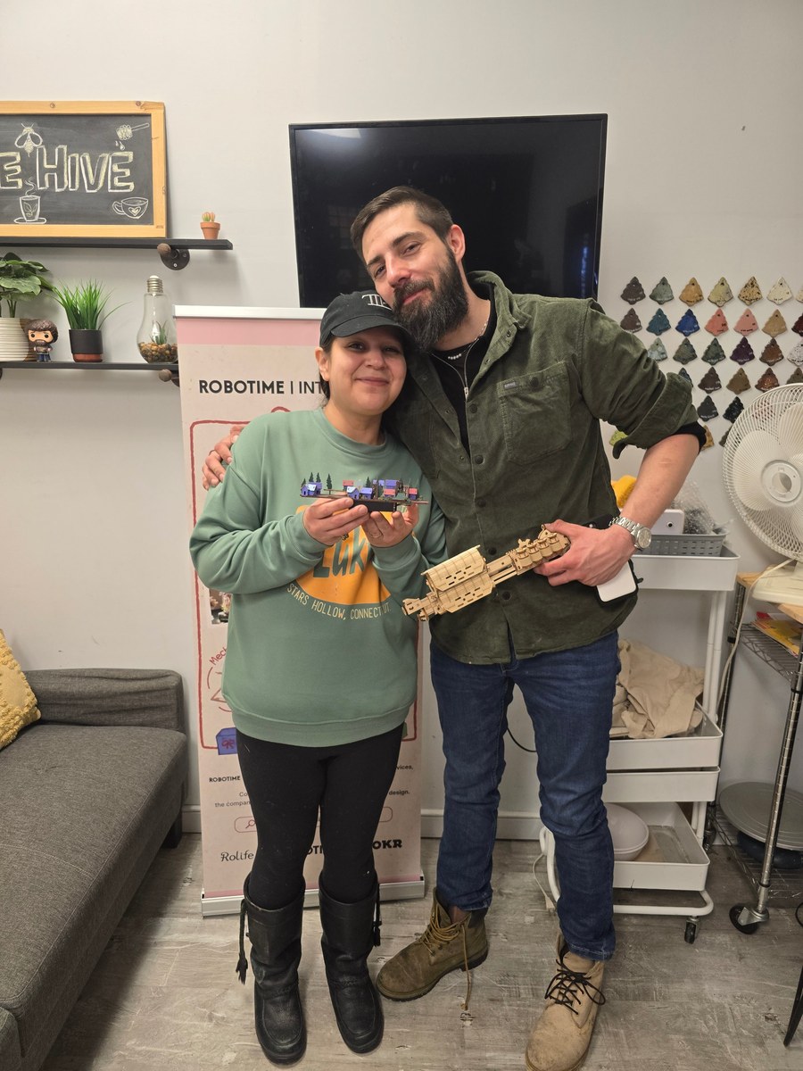 Thunder Bay meetup participants holding completed Robotime builds
