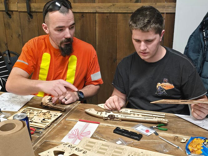 Two participants assembling ROKR mechanical models at the Thunder Bay meetup