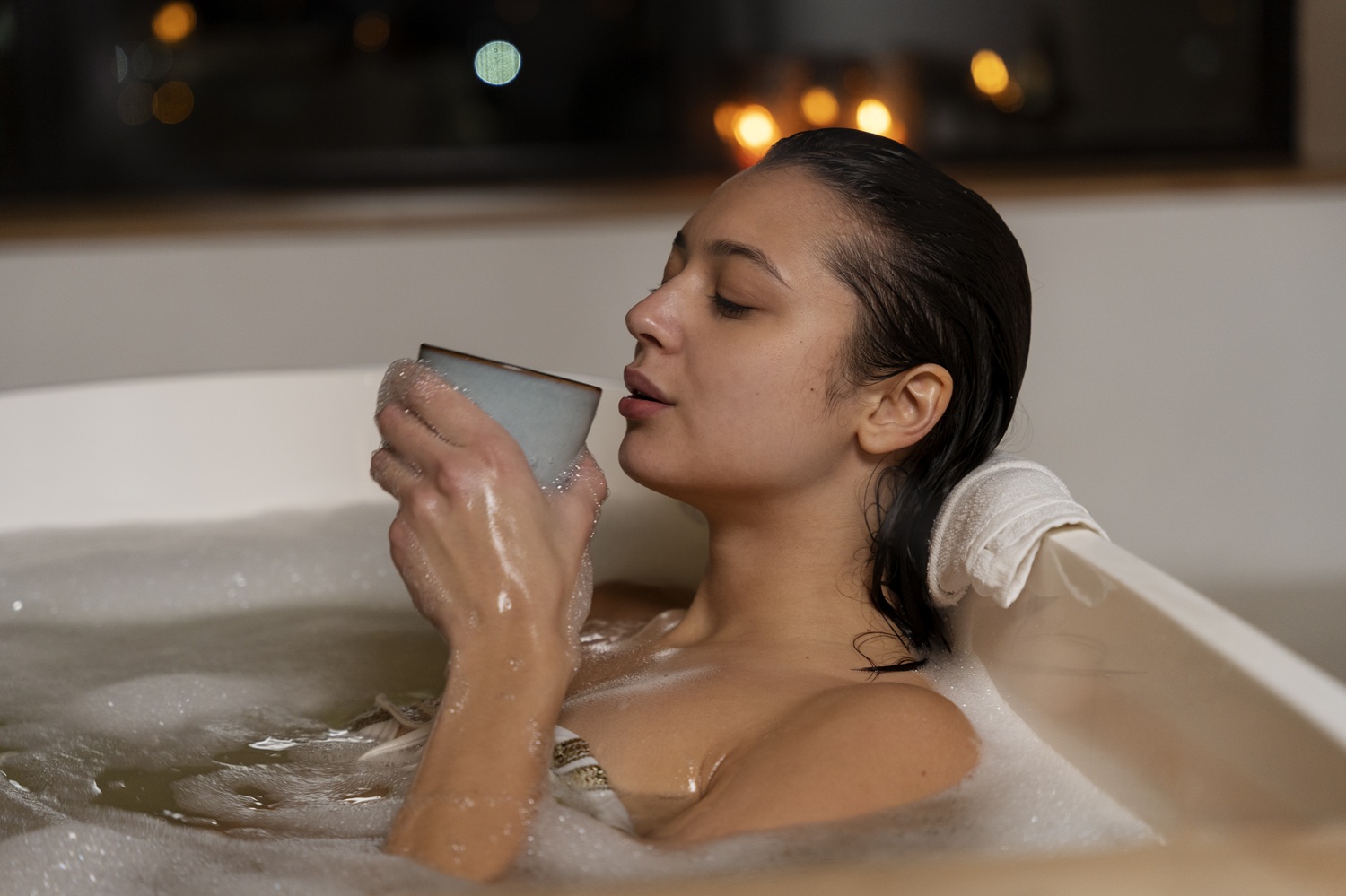 young woman drinking coffee relaxing while taking bath