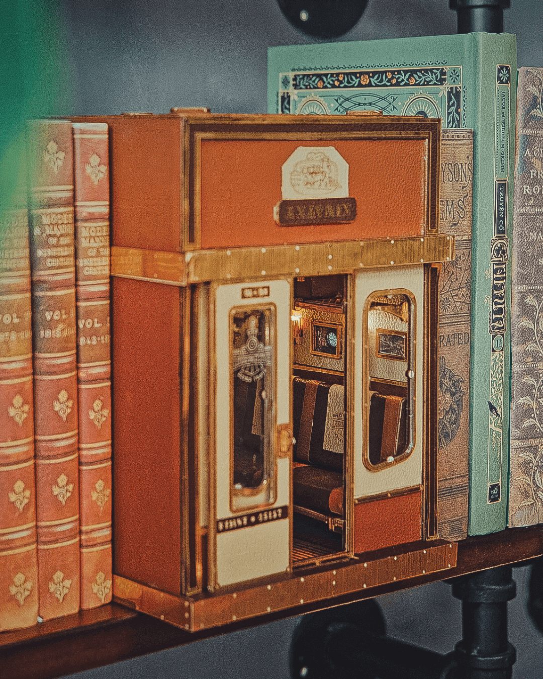 Best crafting for adults: The 1940s Train Cabin DIY Book Nook Shelf Insert Craft Kit by Anavrin with a heavy sliding door and motion scene