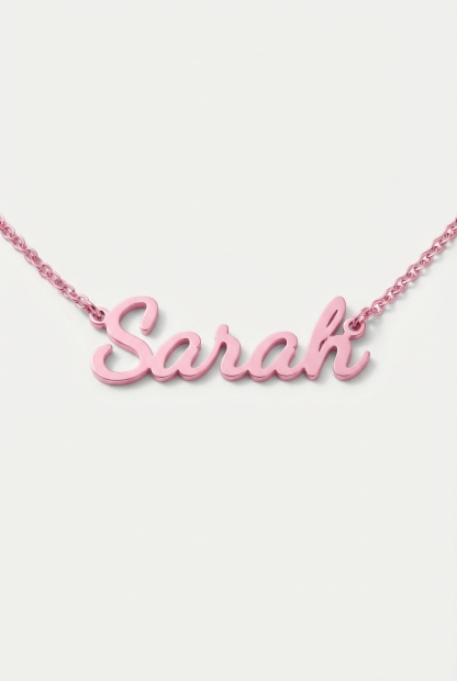 Pink personalized script name necklace on off-white background