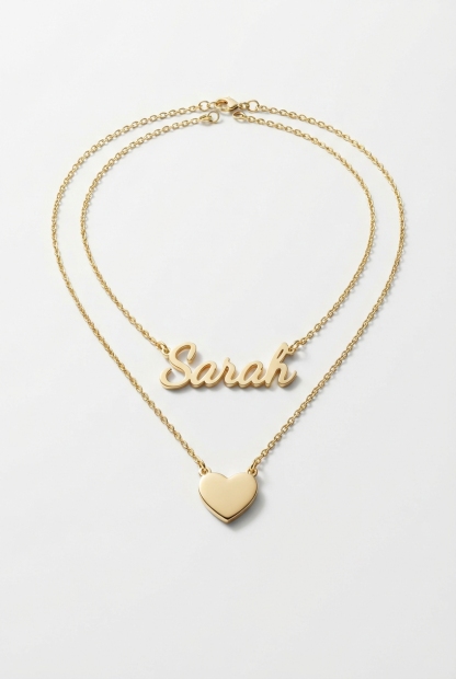 Layered name and heart necklace set on off-white background