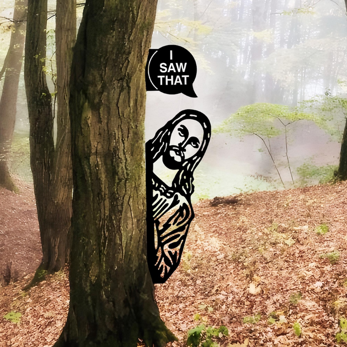 May include: A black cutout of Jesus peeking from behind a tree in a forest setting. A speech bubble above Jesus says, "I SAW THAT". The background features a misty forest with trees and fallen leaves.