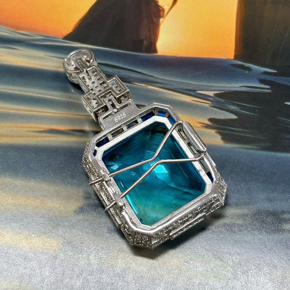 Vintage Emerald Cut Aquamarine Brooch With A Halo Sapphire 
