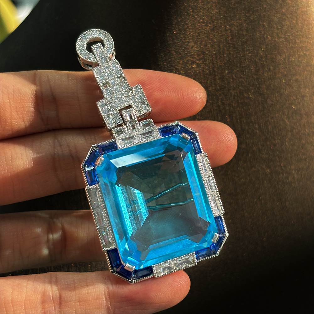 Vintage Emerald Cut Aquamarine Brooch With A Halo Sapphire 