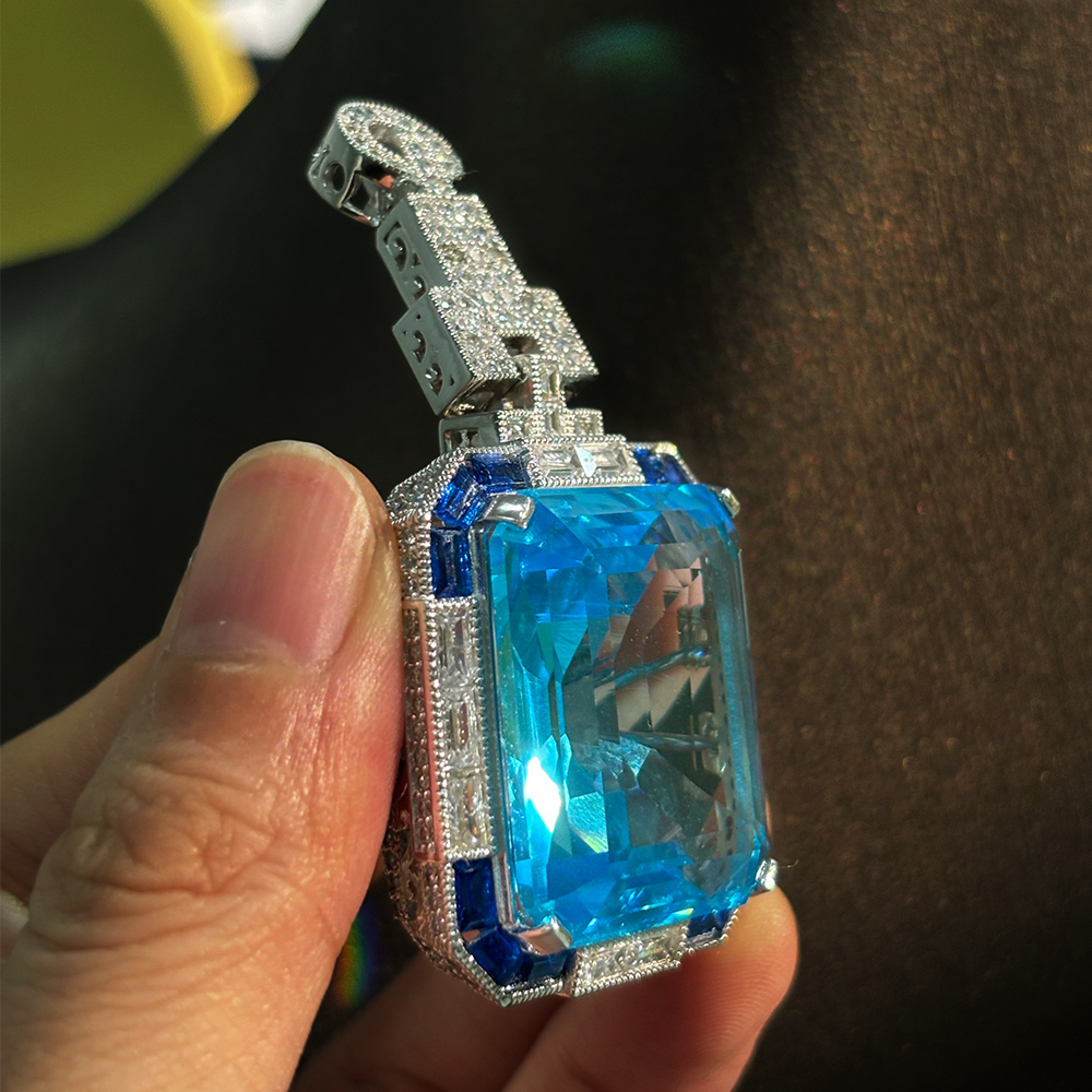 Vintage Emerald Cut Aquamarine Brooch With A Halo Sapphire 