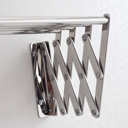 Folded towel rack close to wall