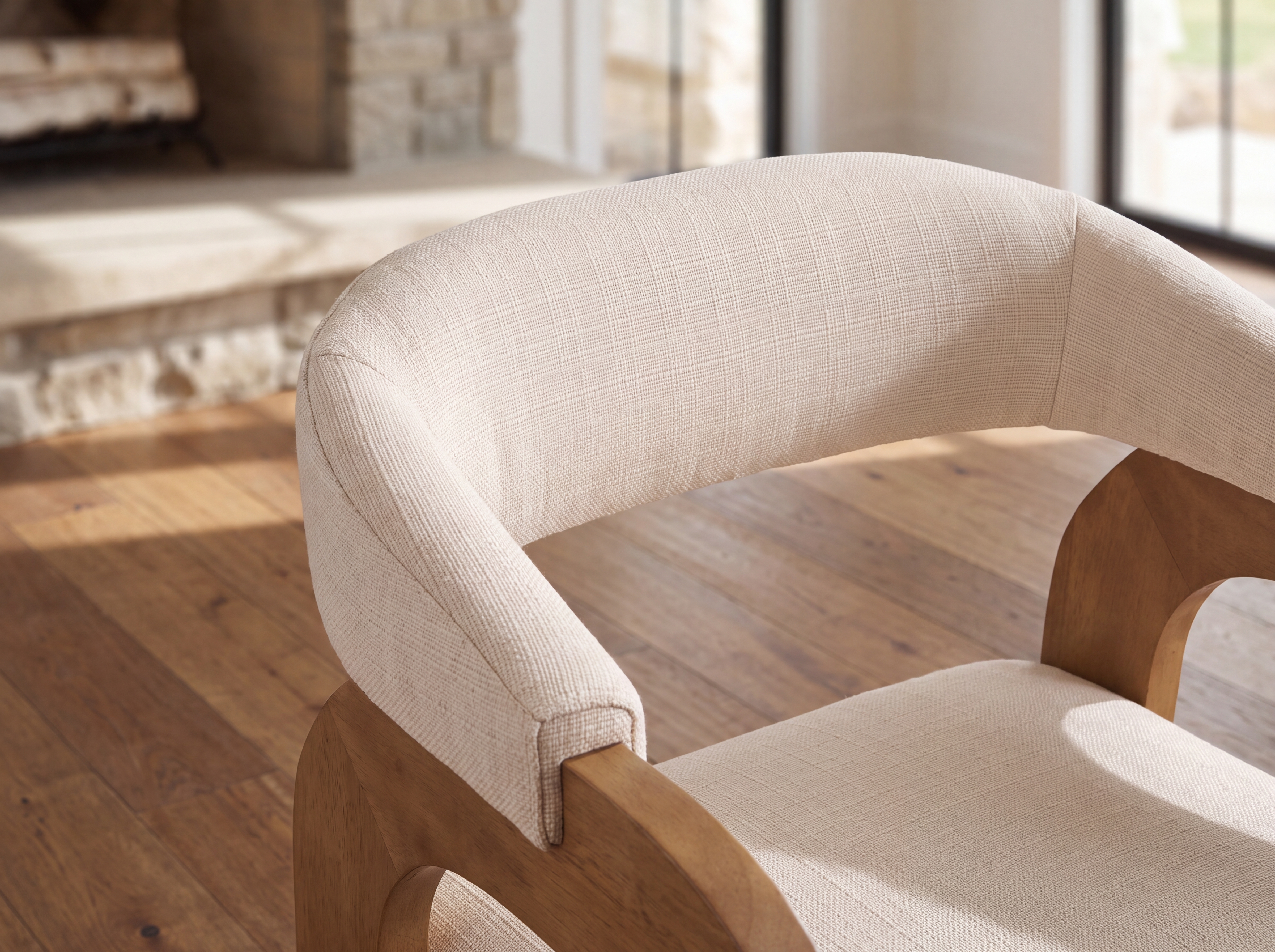 Curved open back and thick cushioned seat of the Clara Dining Chair