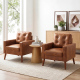 Two mid-century cognac leather luxury sofa chairs with button tufting in a stylish living room interior.