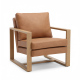 Affordable armchair with brown leather upholstery, solid wood frame, and modern minimalist design in a living room
