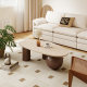 inexpensive modern coffee table with oval marble top and sculptural wood legs styled in bright minimalist living room