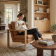 Affordable armchair set with brown leather cushions and solid wood frames, styled in a warm modern living room
