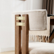 modern solid wood dining chairs featuring upholstered backrest and exposed brass hardware detail, close-up view
